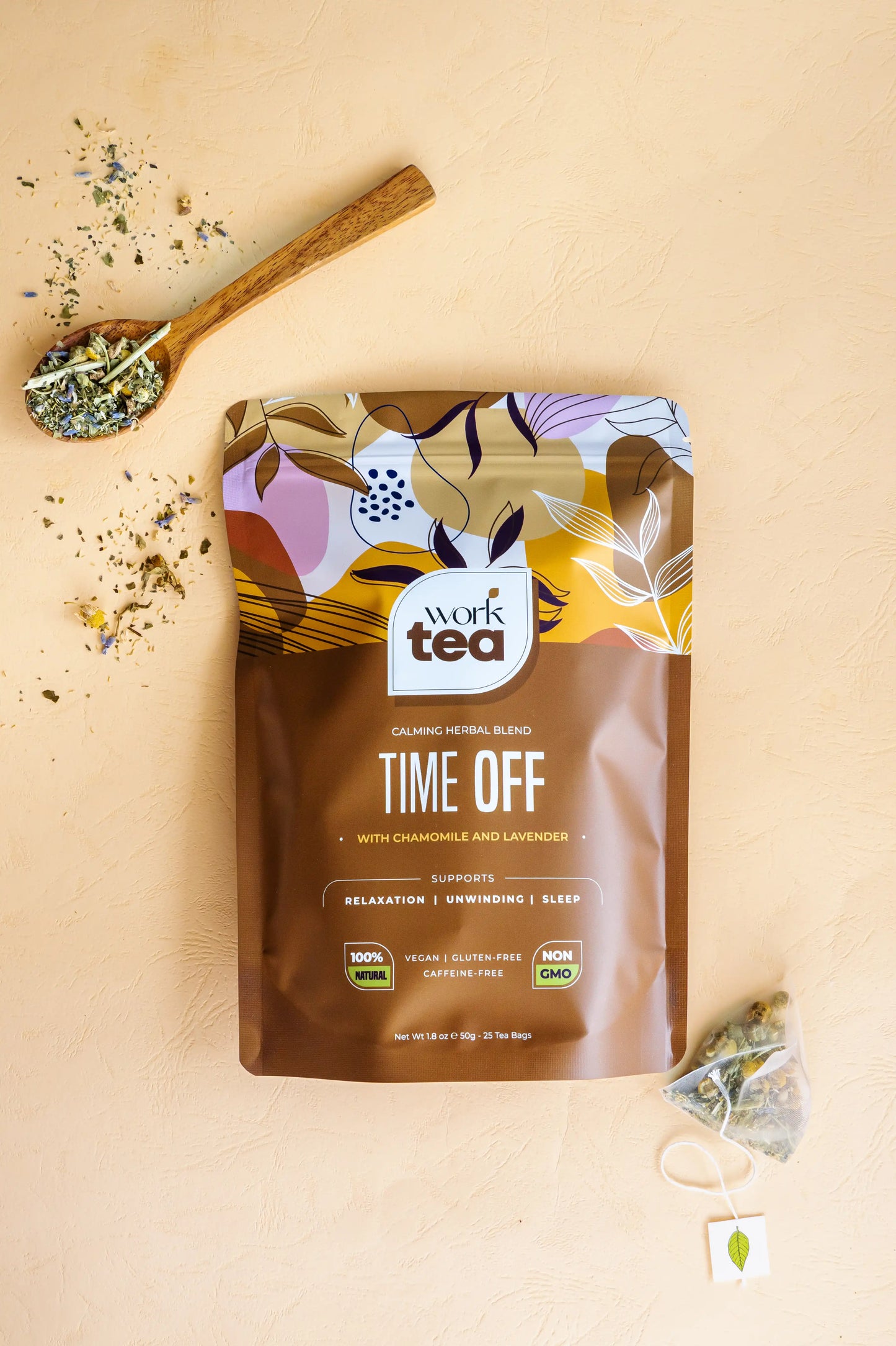 Work Tea 'Time Off' package on a beige background with tea leaves and a spoon.