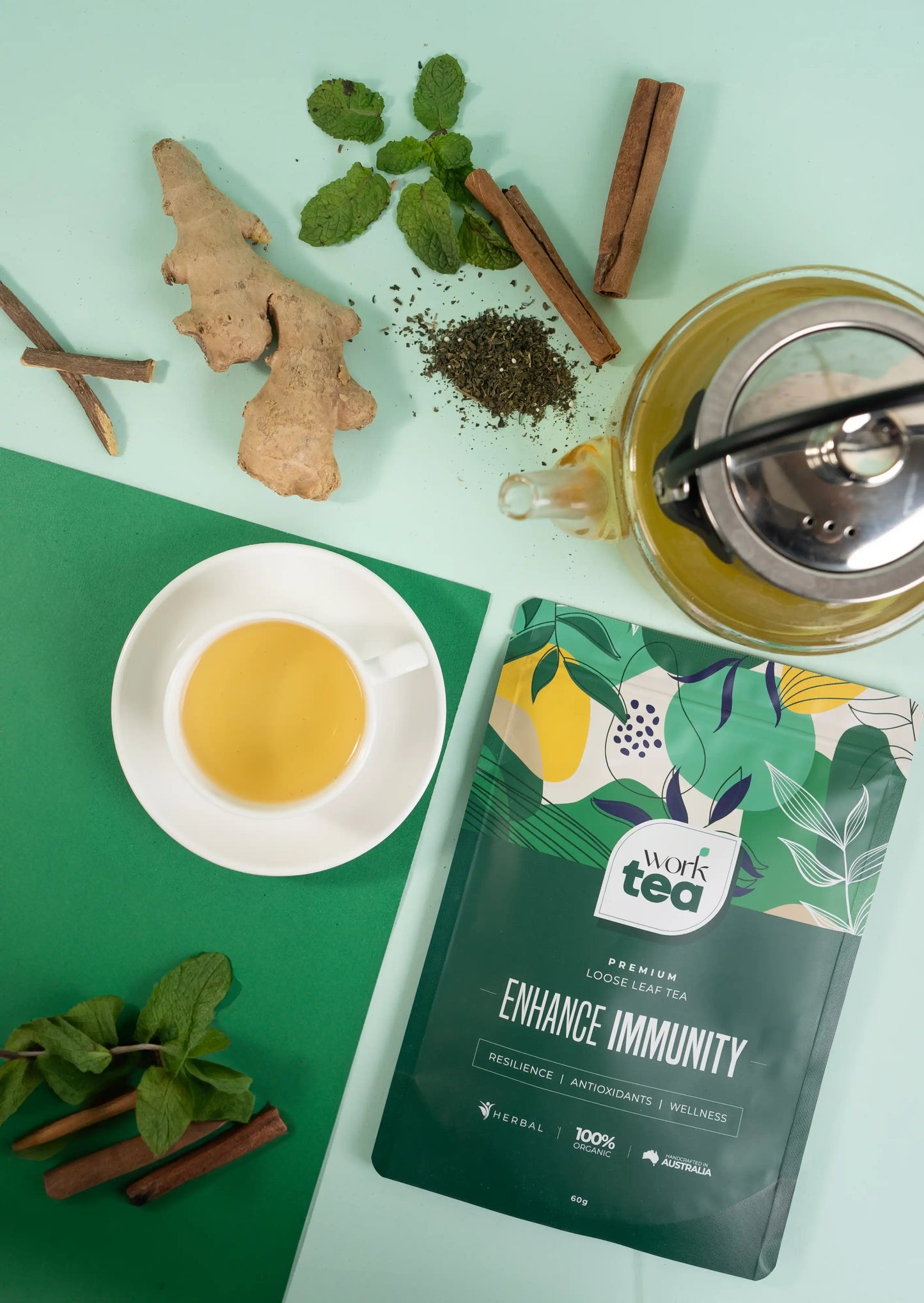 Tea packaging with tea leaves, ginger, cinnamon, and a teacup on a green background