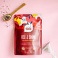 Work Tea 'Rise & Shine' package on a pink background with a spoon and tea leaves.